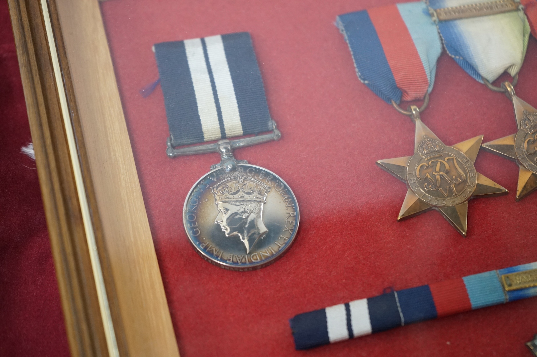 WWII Naval DSM group - framed, to Walter Charles King, comprising a replacement Distinguished Service Medal, the 1939-1945 Star, the Atlantic Star with clasp for France and Germany, the Pacific Star, and the 1939-1945 Me